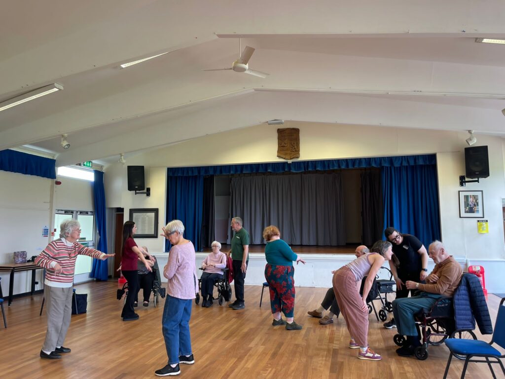 a hall of senior adults exercising to music